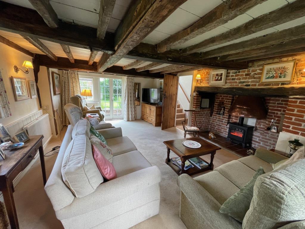 Lot: 145 - DETACHED COTTAGE IN HERTFORDSHIRE VILLAGE LOCATION - Living Room with inglenoon fireplace and exposed beans